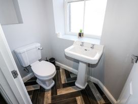 A bathroom with a toilet and sink at Lowther House in Whitehaven