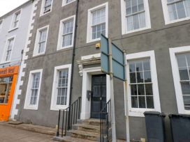 The exterior of a building with windows and a door at Lowther Apartment in Whitehaven