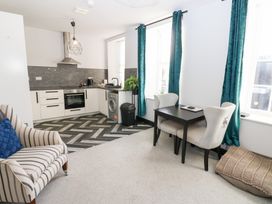 A kitchen with a table and chairs at Lowther Apartment in Whitehaven