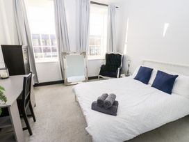 A bedroom with a bed and desk at Lowther Apartment in Whitehaven