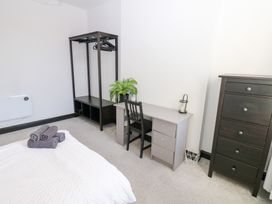 A bedroom with a bed and desk at Lowther Apartment in Whitehaven
