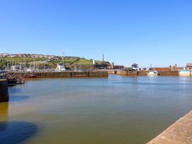 A harbor with boats and buildings in the background at Lowther Penthouse in Whitehaven
