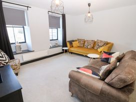 A living room with a sofa and table at Lowther Penthouse in Whitehaven