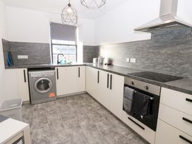 A kitchen with appliances and cabinets at Lowther Penthouse in Whitehaven