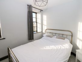 A bedroom with a bed and window at Lowther Penthouse in Whitehaven