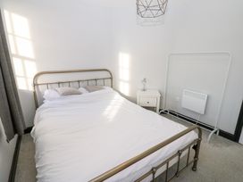 A bedroom with a bed and nightstand at Lowther Penthouse in Whitehaven