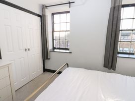 A bedroom with a bed and wardrobe at Lowther Penthouse in Whitehaven