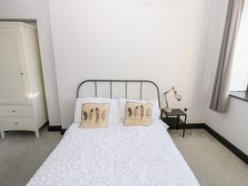 A bedroom with a bed and bedside table at Lowther Penthouse in Whitehaven