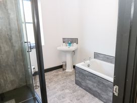 A bathroom with a shower and a bathtub at Lowther Penthouse in Whitehaven