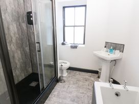 A bathroom with a shower, sink, toilet and bathtub at Lowther Penthouse in Whitehaven