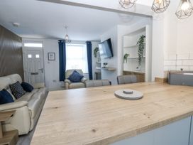 A living room with a sofa and television at Keekle Terrace in Cleator Moor