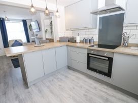 A kitchen with a countertop, oven, and sink at Keekle Terrace in Cleator Moor