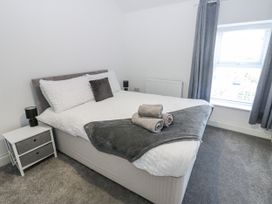 A bedroom with a bed and a bedside table at Keekle Terrace in Cleator Moor