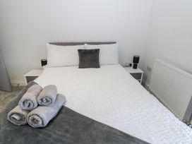 A bedroom with a bed and towels at Keekle Terrace in Cleator Moor
