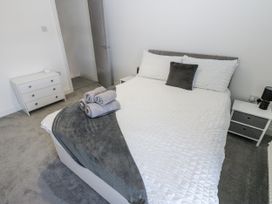 A bedroom with a bed and bedside tables at Keekle Terrace in Cleator Moor