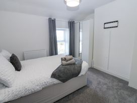 A bedroom with a bed and towels at Keekle Terrace in Cleator Moor