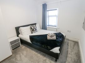 A bedroom with a bed and bedside table at Keekle Terrace in Cleator Moor