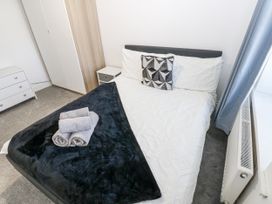 A bedroom with a bed and dresser at Keekle Terrace in Cleator Moor