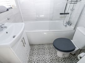 A bathroom with a bathtub, sink, and toilet at Keekle Terrace Cleator Moor