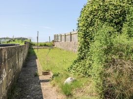 A garden with a path and fence at Keekle Terrace in Cleator Moor