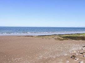 A beach with sand and water at Keekle Terrace in Cleator Moor