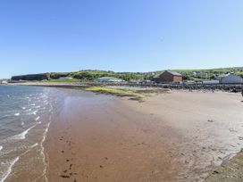 A beach with water and hills in the background at Keekle Terrace Cleator Moor
