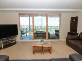 A living room with a television and sofa at Pears Suite in Whitehaven