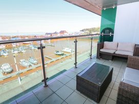 A balcony overlooking a marina with boats at Pears Suite Whitehaven