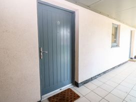 An entrance with a blue door and doormat at Pears Suite in Whitehaven
