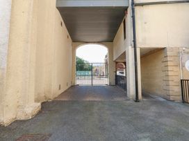 An archway leading to a gated outdoor area at Pears Suite Whitehaven