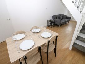 A dining table with plates and glasses at Holly House in Waberthwaite