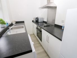 A kitchen with sink, oven, stove, microwave and fridge at Holly House in Waberthwaite