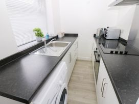 A kitchen with a sink and appliances at Holly House in Waberthwaite