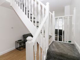 A staircase with a landing and furniture at Holly House in Waberthwaite