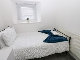 A bedroom with a bed and a window at Holly House in Waberthwaite