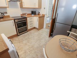 A kitchen with cabinets and appliances at Lonsdale Street