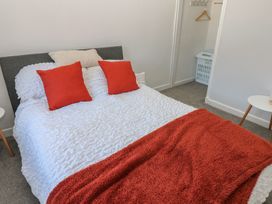 A bedroom with a bed and nightstands at Lonsdale Street 