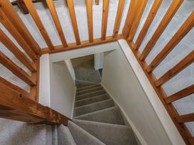 A staircase with wooden handrail and carpet at Lonsdale Street 