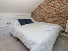A bedroom with a bed and towels at Lonsdale Street 