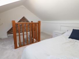An attic bedroom with a bed and railing at Lonsdale Street