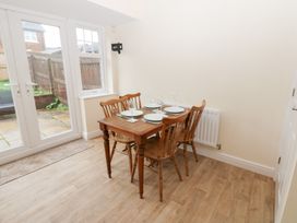 A dining room with a table and chairs at Lingla House Frizington