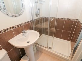 A bathroom with a shower and sink at Lingla House in Frizington