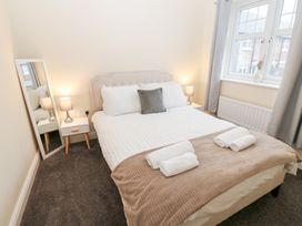 A bedroom with a bed and bedside table at Lingla House in Frizington