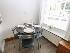 A dining area with a table set for four at Kirkgate Cottage in Cockermouth