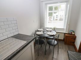 A kitchen with a dining table set at Kirkgate Cottage Cockermouth