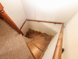 A staircase with wooden steps and a handrail at Kirkgate Cottage Cockermouth