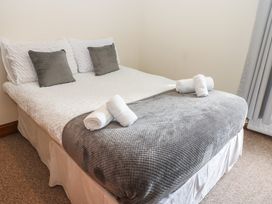 A bed with pillows and towels at Kirkgate Cottage in Cockermouth