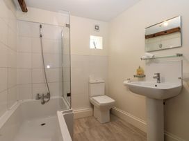A bathroom with a shower and bathtub at Kirkgate Cottage in Cockermouth