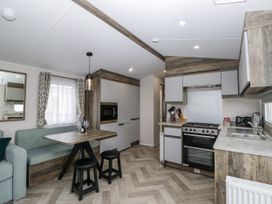 A kitchen with dining area at Puffin in St Bees