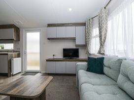 A living room with a couch and television at Puffin in St Bees